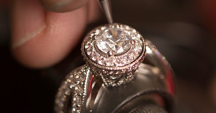 Image of jeweler designing a custom engagement ring.